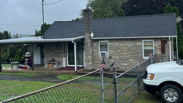 Roofing technician performing a roof inspection to determine if roof repair is needed.