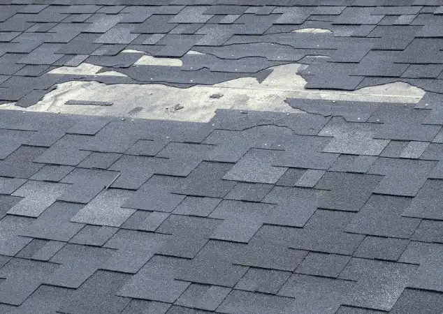 Damaged roof with missing shingles prior to a repair made by DePalma Roofing & Construction in Mechanicsburg, PA