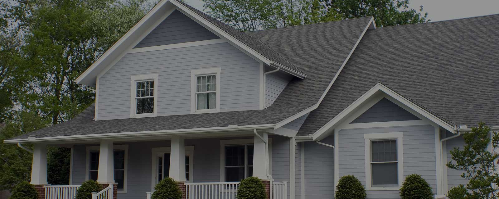 Shingle roof installation job after completion. Front view of home