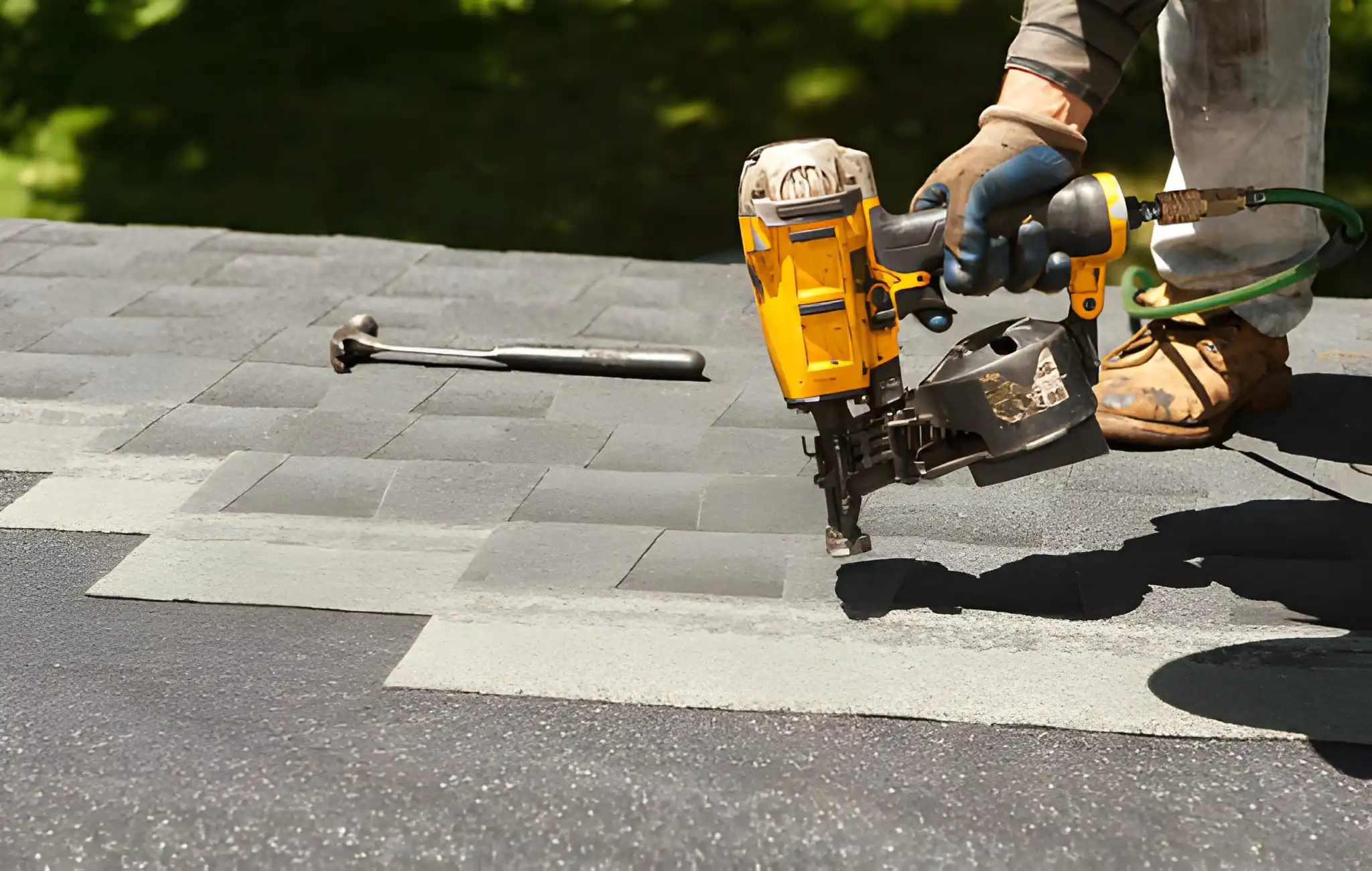 New shingles on residential home using a nail gun.