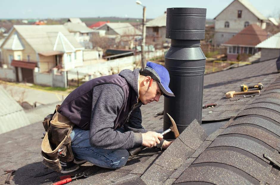 professional roofer repairing the roof